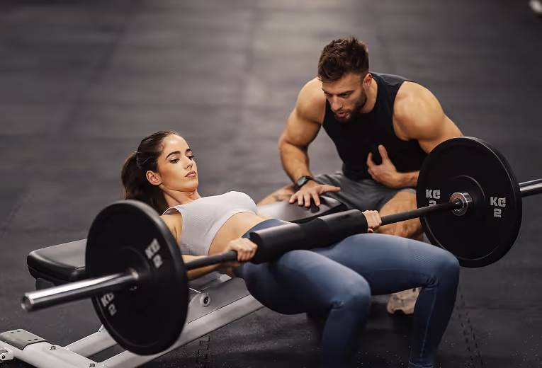 Personal trainer helping client do the workout with weights