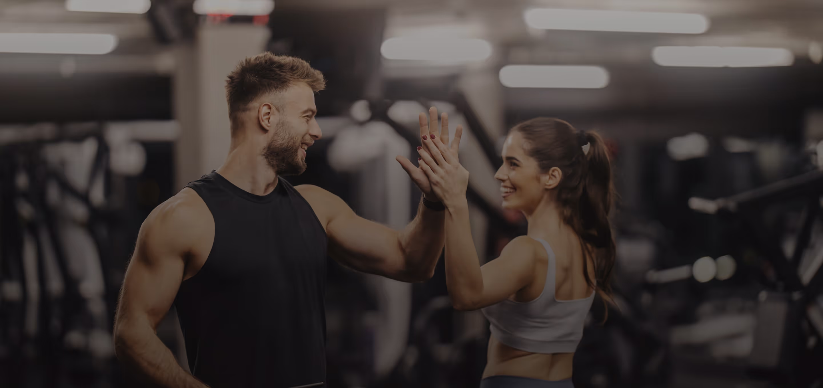 Coach high fives a client after a workout, smiling