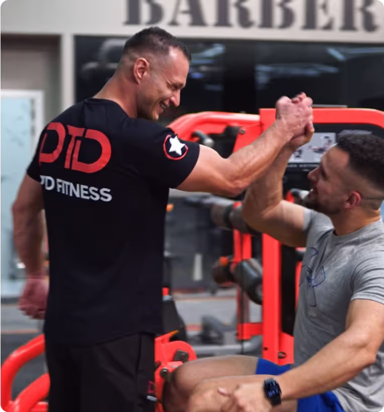 PTD coach and CEO shakes hands with a client celebrating successful workout